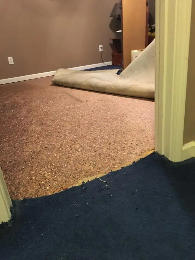 Carpet pad removal revealing water damage during Water Mitigation Services in Lake Mathews
